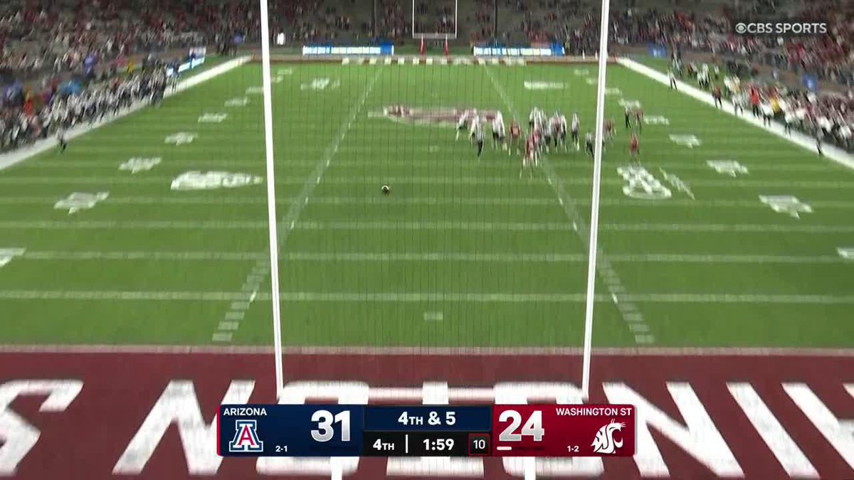 A football can be seen bouncing on the field after a missed field goal attempt, with the scoreboard showing Arizona 31, Washington State 24 with 1:59 left in the 4th quarter on 4th & 5. The ball appears to have hit the goalpost or railing, consistent with the caption noting the kick went off the railing of the stands, narrowly missing a successful field goal.