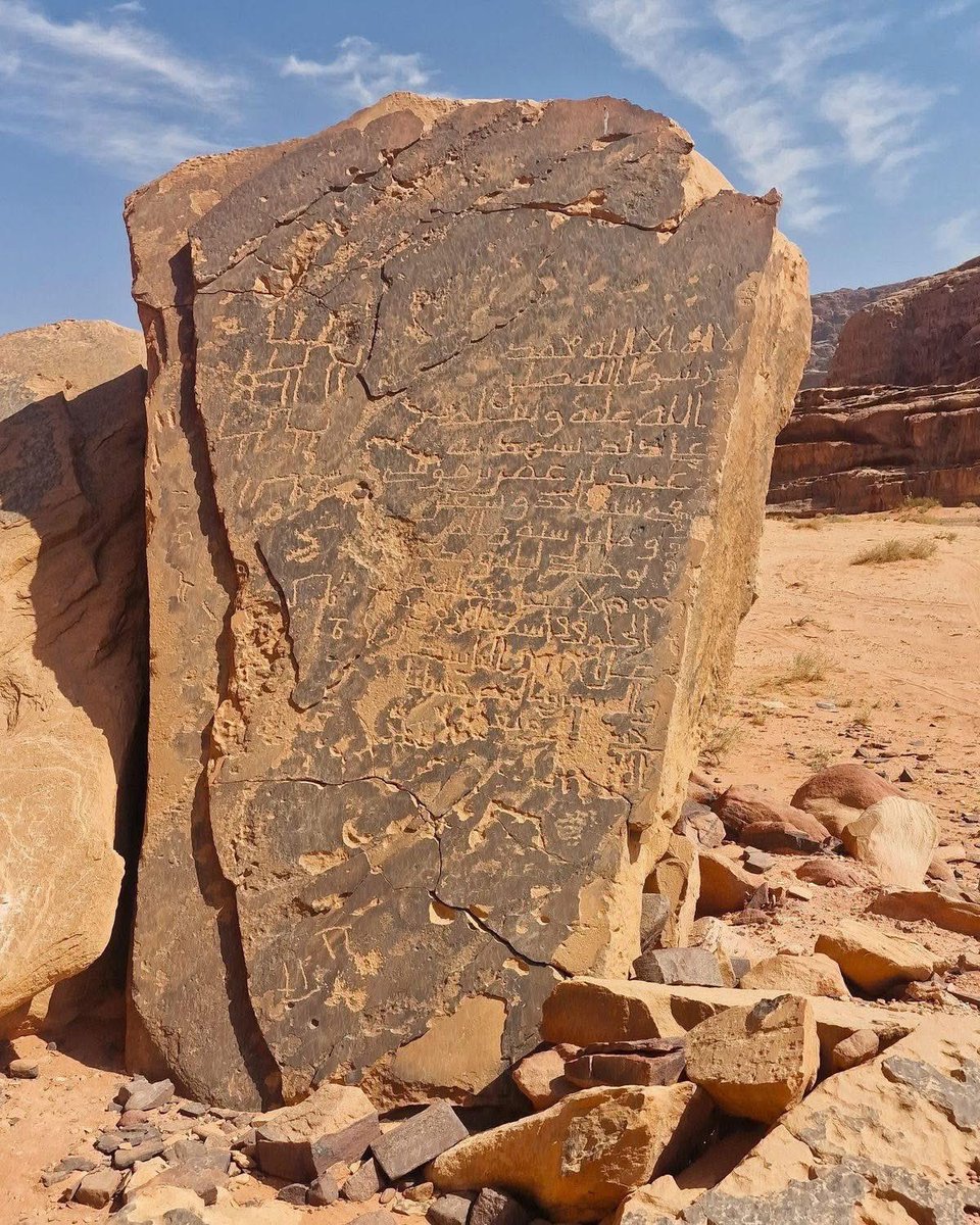 UnearthedHQ's tweet photo. THE DESERT STONE THAT STILL SPEAKS

Hidden in the vast, sun-scorched deserts of the Middle East, an ancient rock face carries a message from a world that disappeared centuries ago. Its dark, weathered surface is covered with deeply carved letters, symbols, and markings, each one cut by human hands long before the modern world existed.

Some inscriptions appear to preserve names, journeys, prayers, or moments from the lives of people who once crossed these empty lands. Others remain difficult to understand, their meaning slowly fading beneath centuries of wind, sand, and time. What makes the scene even more mysterious is the way newer markings seem to overlap older ones, creating layers of human history on the same stone.

Perhaps these were travelers who wanted to be remembered. Perhaps they were messages meant for someone who would come after them. Or perhaps some of the symbols still hold stories we have not learned to read.

The desert has buried countless secrets. But somehow, this stone kept one of them alive.

And after hundreds or even thousands of years, its silent message is still waiting to be understood.