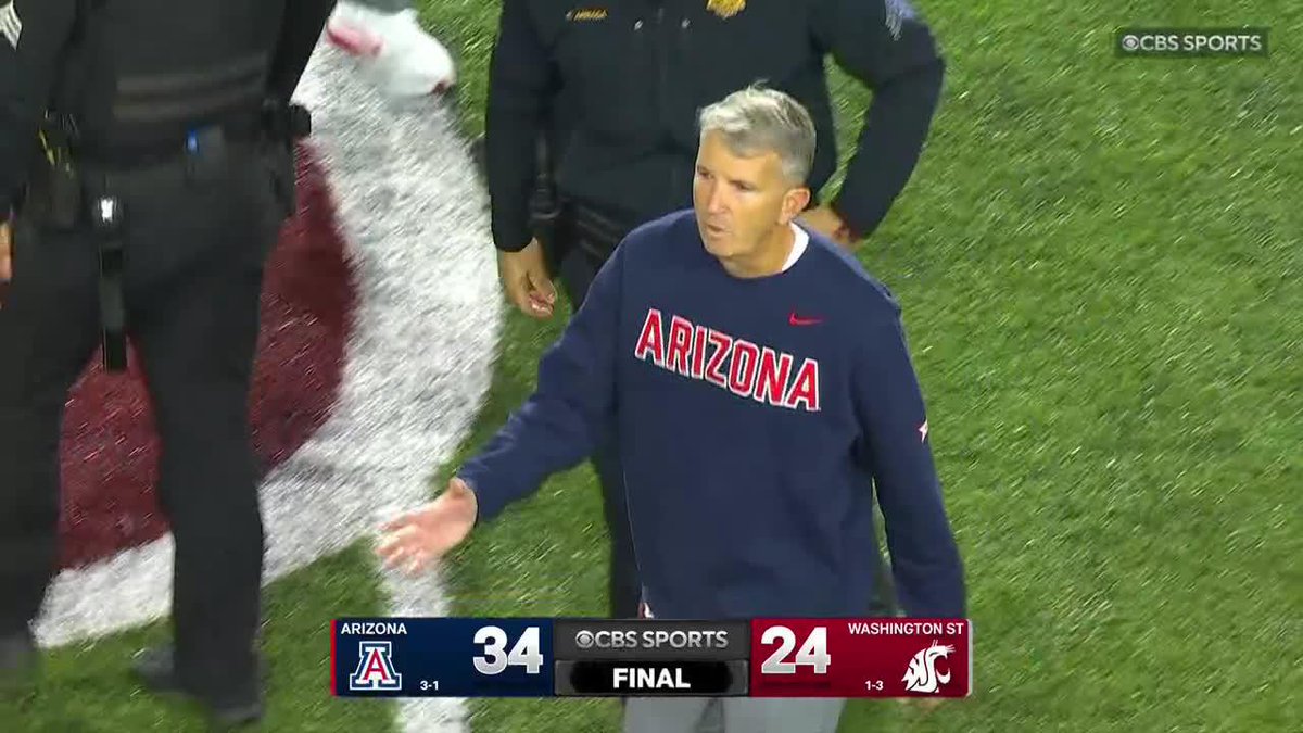The Arizona head coach shakes hands on the field after his Wildcats defeated Washington State 34-24, improving to 3-1 on the season while the Cougars fell to 1-3.