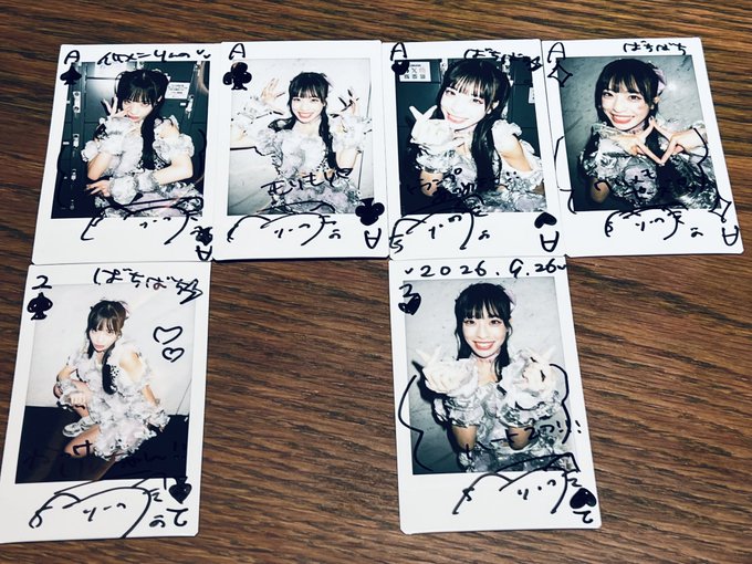 Six Polaroid-style photos arranged on a wooden surface, showing a smiling Japanese woman in decorative outfits with handwritten messages and dates including '2026.4.26'.