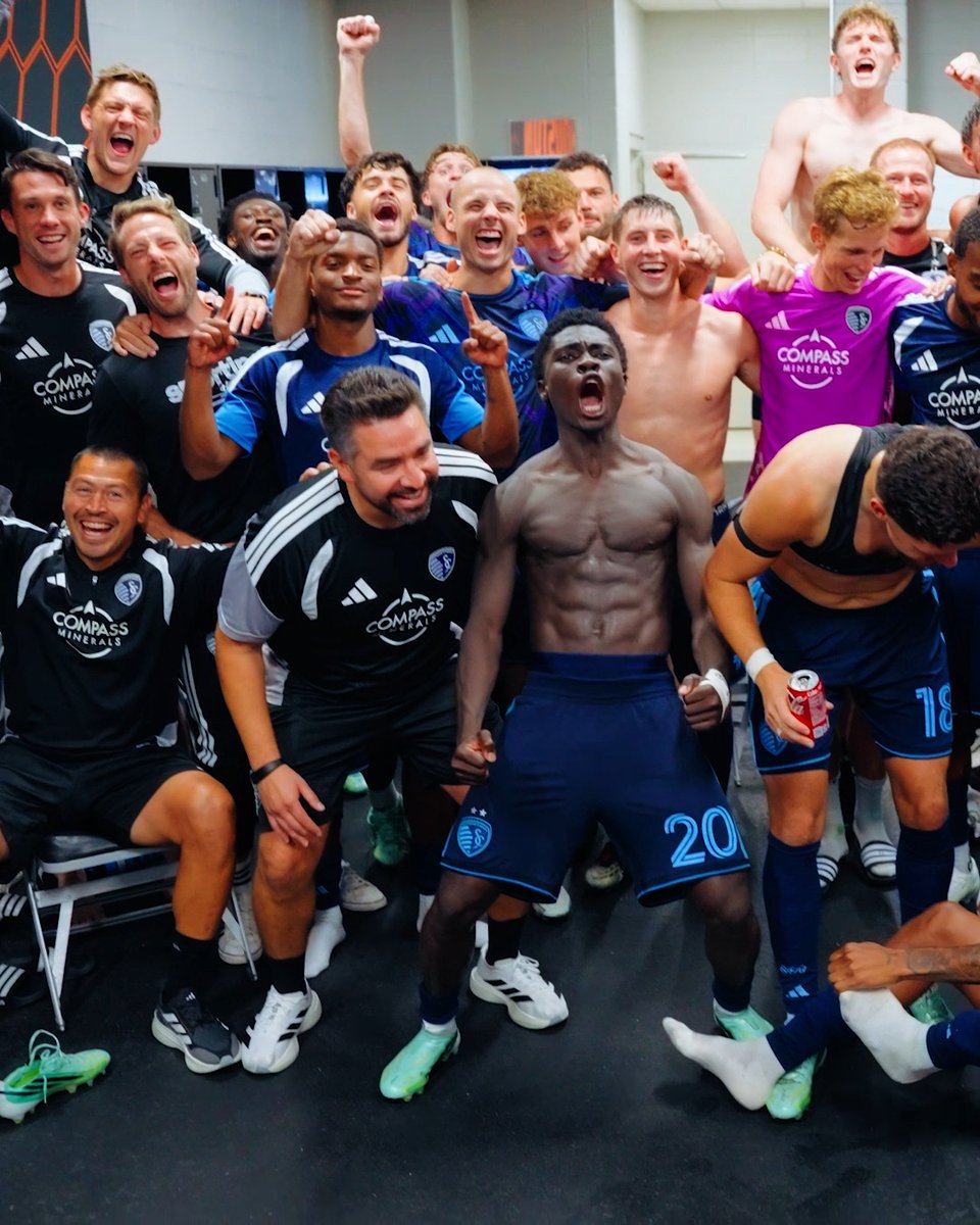 A jubilant Sportsing Kansas City soccer team, identifiable by their Adidas kits featuring the "COMPASS MINERALS" sponsor logo, celebrates in the locker room, with players wearing the number 20 and 18 visible among the group. The image perfectly captures the post's caption, as the players' ecstatic celebration visually represents the joy of earning "3 points & a clean sheet" for a guaranteed good night's sleep.