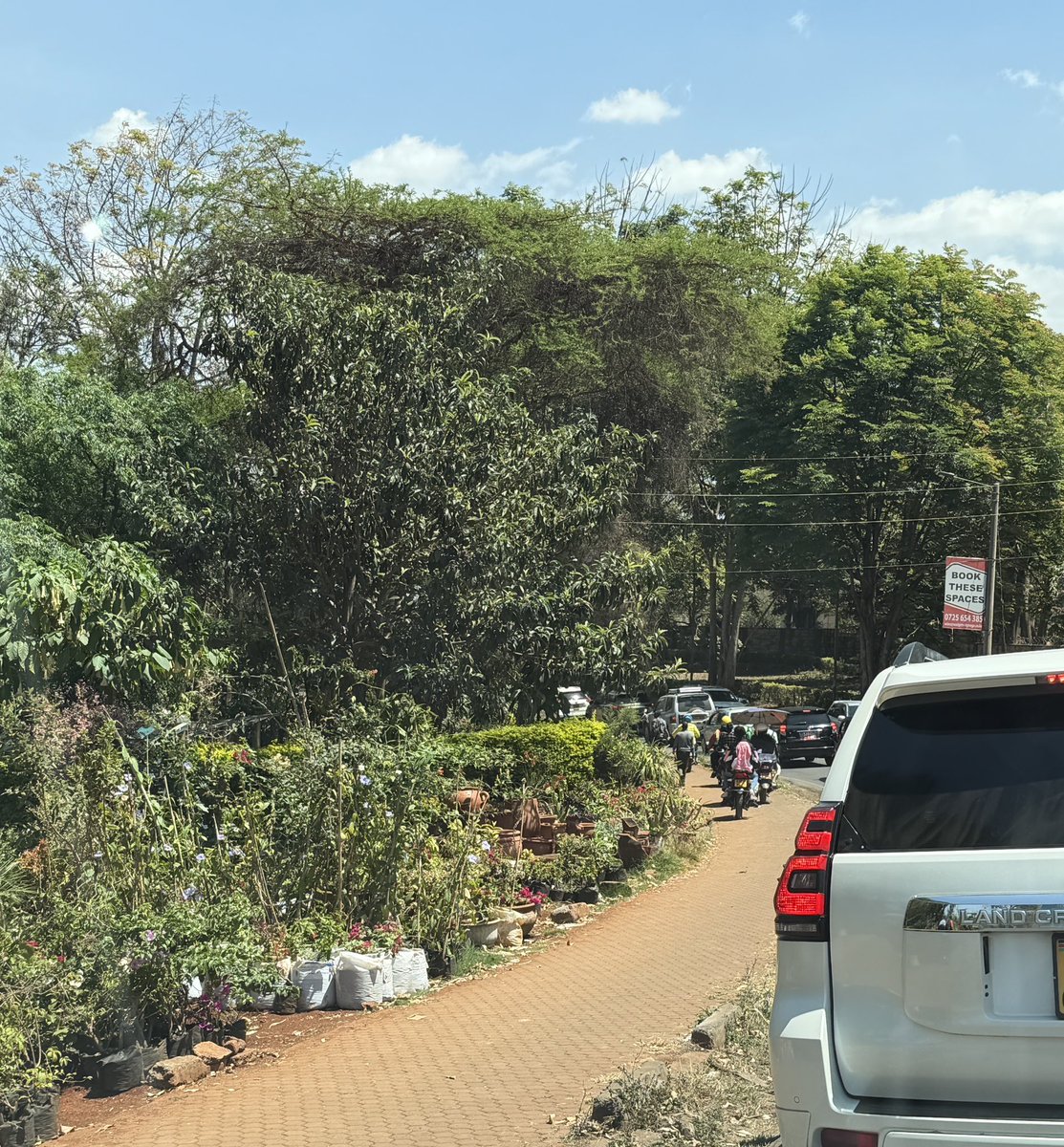 Alfayaz11's tweet photo. Dear @KeNHAKenya, kindly take a drive along the Redhill Bypass and see what is happening.

The pedestrian walkways and paths are slowly being taken over by tuk tuks, while small stalls and vibandas are mushrooming along the entire bypass. Why can’t we have an organised way of accommodating eateries and small businesses, as we see along major highways in many of the countries we constantly say we want to emulate?

Meanwhile, our national failures @ntsa_kenya can happily come and arrest pedestrians while ignoring the lawlessness happening right in front of them.

The damage being done to the infrastructure and kerbs is clearly visible, with tuk tuks and boda bodas illegally crossing the bypass and creating stages along the road.

Incompetence, corruption and lack of enforcement are slowly destroying what was once a beautiful and organised city. At this rate, I will not be surprised to see full markets, boda stages and tuk tuk termini mushrooming along the entire bypass. We watch disorder begin, allow it to become normal, then wonder how we got here.

#ReclaimNairobi