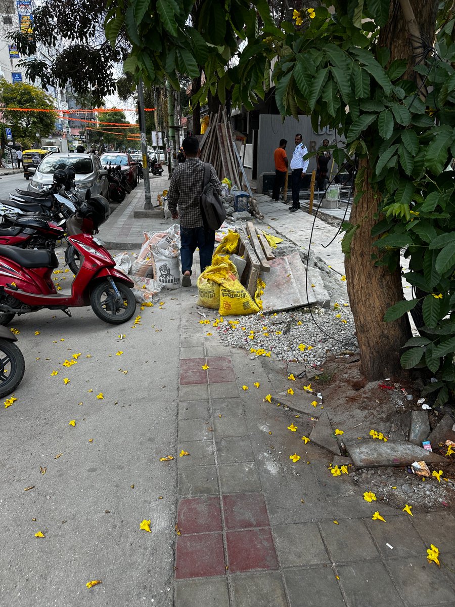 Jameshwari's tweet photo. @GBA_office illegal dumping of construction material on the footpath and drilling and loud construction on Sunday. Please take cognisance and action. This is on the CMR main road, opposite Manyavar showroom, Kalyan Nagar. This violation has been going on since March 2026. https://t.co/TBmwp6eZro