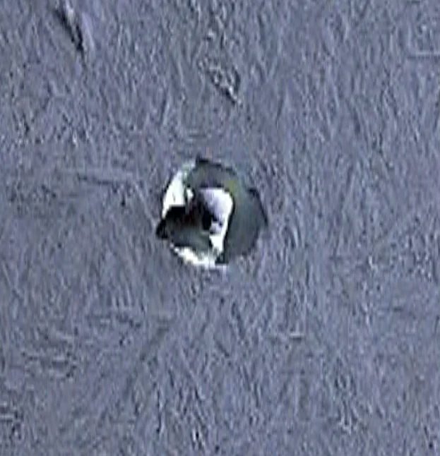 maniaUFO's tweet photo. What is this object on an extremely remote volcano in Antarctica?
Coordinates: 76°17′14″S, 112°09′33″W

We're looking at Mount Takahe, an extremely remote Antarctic volcano, at roughly 3,300 m elevation and ~170 km from the coast.

There are three unusual-looking objects inside the crater. The two on the right could simply be small snow formations caused by wind. But the one on the left really caught my attention.

It looks like an approximately 11 m-wide spherical object sitting on top of the snow, with what appears to be a small depression or valley around it. You can even see what looks like a shadow cast by the object.

I have no idea what this could be. A natural formation? Something left there by humans? Some kind of equipment? My first thought was a weather balloon or similar object that somehow ended up here.

Does anyone recognize this formation, or have a better explanation?