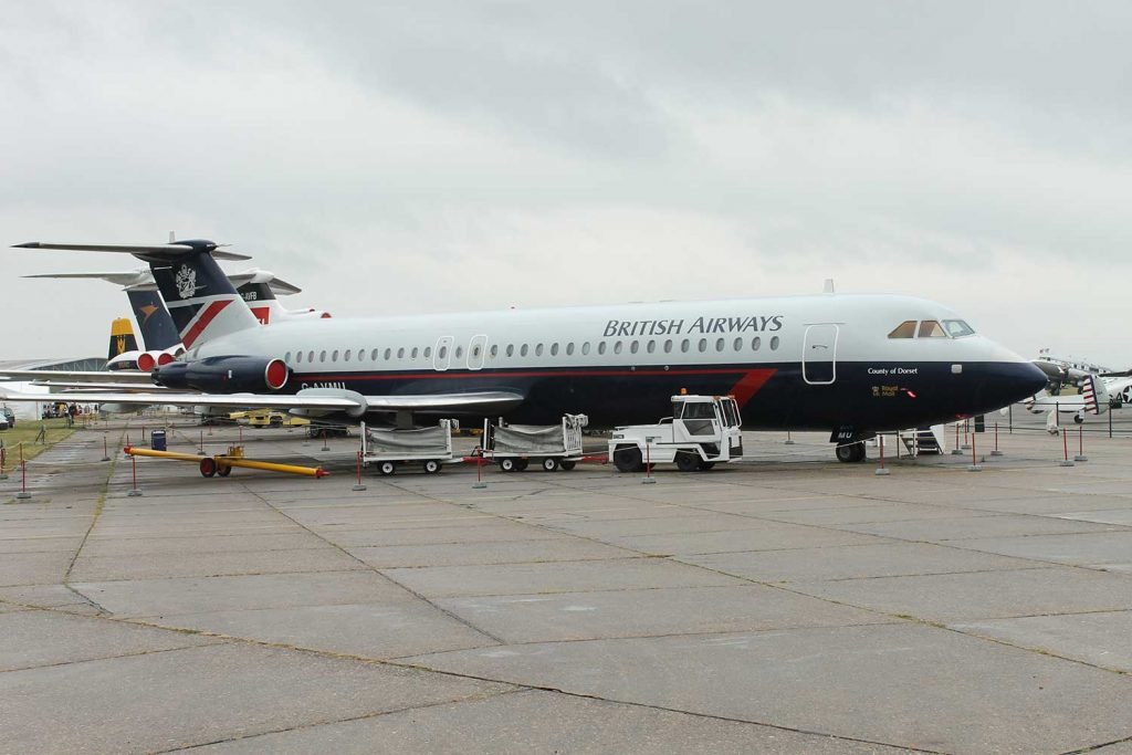 UKBorderWatch's tweet photo. This BAC 1-11 cabin made me forget Concorde

At IWM Duxford near Cambridge, I stepped aboard British Airways BAC 1-11 G-AVMU and found the ordinary passenger world I had come to meet.

I had meant to make straight for Concorde, but the narrow aisle made me turn back for a second look.

The five-abreast cabin-two seats on one side, three on the other-explains its slim fuselage more clearly than a diagram.

Dark blue seats, bright red headrest covers and those little windows suddenly made it easy to picture the familiar shuffle of coats and bags before departure.

I left smiling because one modest cabin had made an old journey feel close enough to join.