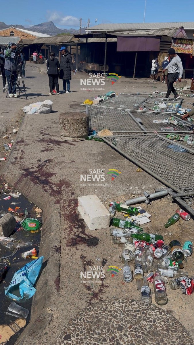 SABCNews's tweet photo. [IN PICTURES] There are scenes of shock and disbelief in the Strand community of Lwandle following this morning's a mass shooting in which ten people were killed at a popular entertainement venue, eleven others were wounded. 
📸: Vanessa Poonah https://t.co/FTkWfp2qh1