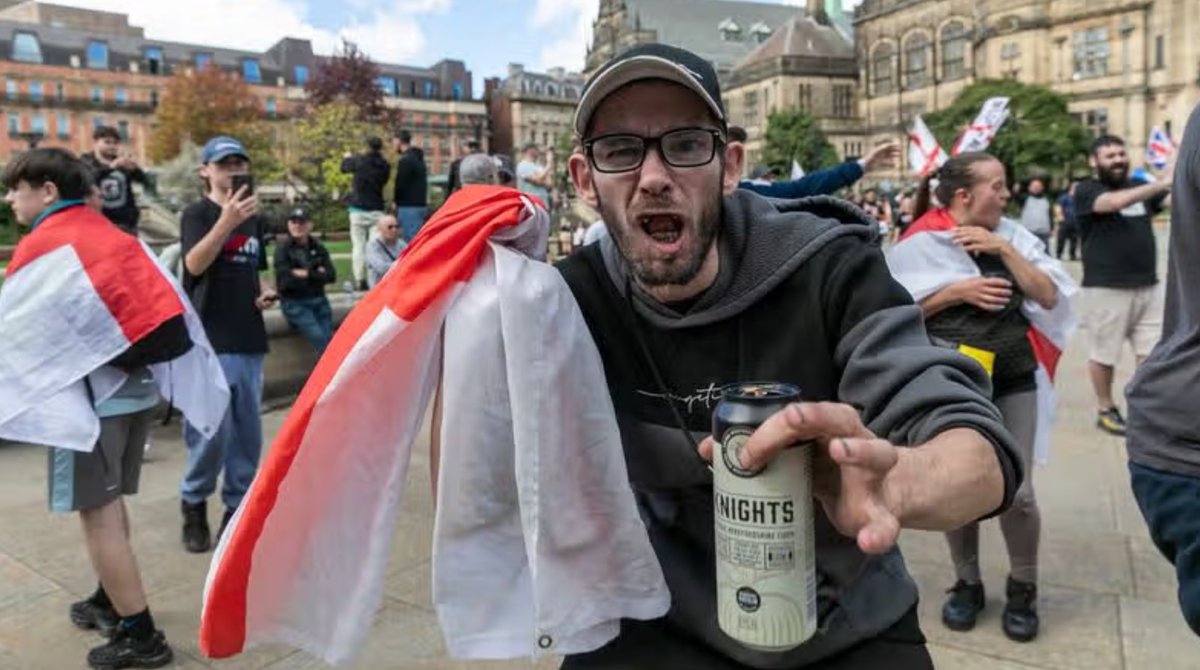 MittensOff's tweet photo. This lad protesting in Sheffield is proudly displaying all the hallmarks of a “true patriot”: the polyester flag, the toothless yawp, the grime‑caked fingernails, and the 8.4% tin of super‑strength cider. https://t.co/MwVUPiBLoD