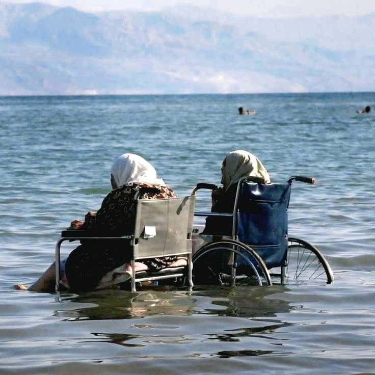 Iman4ii's tweet photo. Two elderly Palestinian women enjoying the Dead Sea in wheelchairs West Bank October 2 2008 https://t.co/cnPzs68Y1s