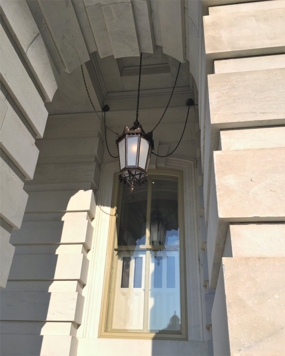 CrenshawLight's tweet photo. A lit portico lantern at the U.S. Capitol — part of the lighting Crenshaw provided for the Stone and Metal Preservation North Extension project, which took home an Award of Merit for Government/Public Buildings. https://t.co/FMR5XMj0cd