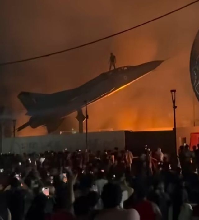PicturesFoIder's tweet photo. A student climbs atop a MiG-23 fighter jet during protests at Lovely Professional University over an alleged sexual assault case in India https://t.co/jmOEWSKJEp
