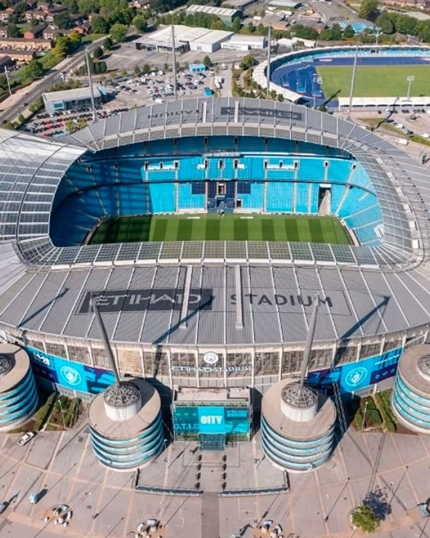 awoyemijoshua61's tweet photo. 🏟️🔵 HOW MANCHESTER CITY GOT THE ETIHAD STADIUM IS A STORY MANY PEOPLE DON’T KNOW.

Manchester City do not own the Etihad Stadium. Manchester City Council does.

And the stadium wasn’t originally built for Manchester City.

It was built for the 2002 Commonwealth Games, after Manchester’s failed Olympic bids. The council wanted an 80,000-seat athletics stadium on the old Bradford Colliery site in Eastlands.

Construction began in December 1999. Tony Blair laid the foundation stone.

The stadium cost £112 million to build — including £77 million from Sport England lottery funding, with the rest coming from Manchester City Council.

It opened in July 2002 for the Commonwealth Games.

After the Games, the athletics track was removed and the stadium was converted into a football ground. The pitch was lowered and around 23,000 permanent seats were added.

That conversion cost more than £40 million, with around £22 million coming from Manchester City Council and about £20 million from Manchester City for bars, restaurants and corporate facilities.

Then City moved in for the 2003/04 season.

The club signed a 250-year lease from Manchester City Council on a fully repairing basis — meaning City became responsible for running, maintaining and developing the stadium while retaining the revenue generated from it.

The original rent was based on ticket income above 35,000.

Then came the Abu Dhabi takeover.

In 2010, the arrangement was renegotiated. City secured the right to sell the stadium naming rights, eventually leading to the Etihad Airways deal, while agreeing to pay Manchester City Council a fixed £3 million per year, rising with inflation.

In 2011, the stadium officially became the Etihad Stadium.

Since then, City have funded further expansions themselves, taking the capacity from around 47,000 to more than 61,000.

So no, Manchester City weren’t simply handed a stadium for free.

But they also didn’t build the original £112 million stadium themselves.

Public lottery money helped build it. Manchester City Council helped build it. The council funded much of the football conversion. And City obtained a 250-year lease.

That’s the history of how Manchester City ended up at the Etihad. 👀