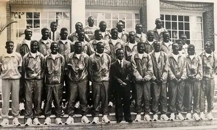 CastroWawa6176's tweet photo. Zambia national football team in 1992 at state House with the late second republican president of zambia Dr Frederick Chiluba before the team left for Africa cup of nations in senegal. 

This was the first Africa cup of nations appearance for my father although he was an unused substitute and he was the only player that was selected from mufulira wanderers football club.

This was when he joined the national team as a young star and because he spent the entire tournament on the bench, as he returned home soccer fans teased and nicknamed him "Senegal 92". ( name of the host country and the year it was hosted).

Dad was a footballer with full of nicknames. In zambia he was famously known as "wawa" or "madjer" from the Algerian striker Rabar mustapha madjer, "Senegal 92" from that tournament and also "Muhammad" from Saudi arabia.

Who can spot him from this photo?