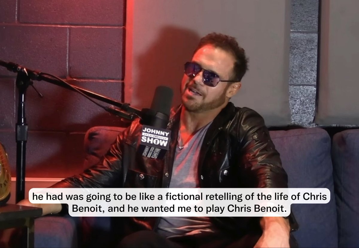 A man in a leather jacket and sunglasses sits on a couch with a "Johnny Show" microphone, explaining how he was asked to portray Chris Benoit in a fictional documentary. The caption references his explanation that the script portrayed Eddie and Chris unfavorably, leading to his rejection of the role.