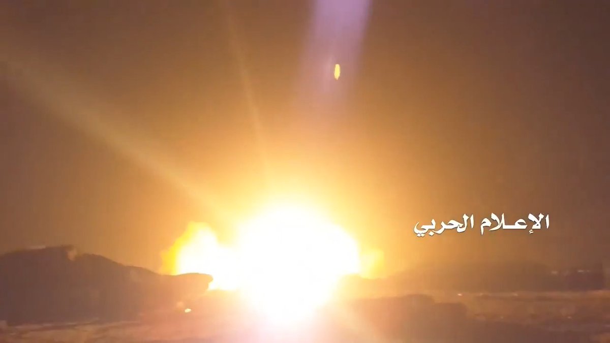 A bright explosion illuminates the dark sky, with Arabic text in the lower right reading 'الإعلام الحربي' (Military Media).