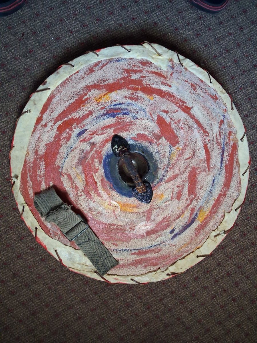 VolkNewsDotC0m's tweet photo. This Viking shield has hung on my print shop wall for years looking hideous. Finally got around to painting it. Wood, steel, leather, canvas, and a rim of soaked pet-store dog bones bent around the edge. Might add to the design later — for now it's done. https://t.co/BHNFDUhYPd