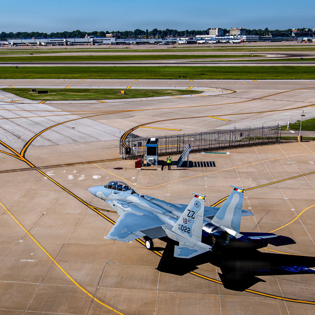 kadonkey's tweet photo. A USAF Boeing F-15EX Eagle II leaving the old McDonnell Douglas factory site in St. Louis on 28AUG26. The first Eagle (F-15A) was rolled out in the exact same location on 26JUN72. (m. bermudez) https://t.co/Pbm22w2SUb