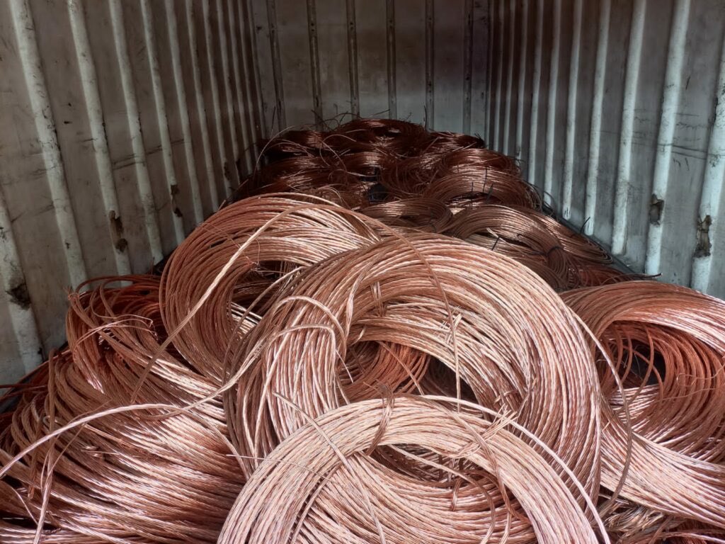 JvanLogg's tweet photo. When we think of copper theft, we tend to picture a crook in the dark, hacking away at a cable. It isn't just that. Not anymore. It is far more complex. 

Syndicates have systematically been stripping Eskom, Transnet, PRASA, Telkom, and our municipalities, and then washing that metal right through local scrapyards and export channels.

Scams: 

1. Cut the lines, burn the sheaths in the veld to destroy the evidence, and sell it into the system as legitimate "scrap."
2. Pack the stolen scrap into containers and misdeclare it at the ports as raw/unrefined copper, or even non-metallic goods to bypass export controls.
3. Smuggle Copperbelt slabs in, file off the serial numbers, and blend them with stolen local scrap for export.

The numbers are staggering. In 2022, the DTCI and TIPS estimated that we trade about 150,000 tonnes of copper scrap a year, worth over R10 billion. Roughly two-thirds of that is smuggled, stolen, or mislabelled.

Cape Town’s anti copper theft unit (Copperheads) put utility insider involvement at around 25%.

The economic damage is devastating. Genesis/DTCI calculates over R45 billion in annual economic damage. 

In 2021 alone, four of our major SOEs took a R7 billion direct hit, with associated impacts up to R187 billion.

Your local municipality is bleeding, too. City Power logged 2,000 incidents in 2022/23, spending R380 million to replace cable in just 8 months. eThekwini is losing about R120 million a year (averaging 80 cases a month).

SAPS had a dedicated, specialised cable theft unit until 2000. Late, corruption-convicted commissioner Jackie Selebi shut down specialist units in SAPS. Syndicates formed and became more brazen. 

When global commodity prices surged, opportunities came for crooks.

2002–2005: Paulos Moyana’s Free State syndicate cut Eskom 88 kV lines. We saw 24 convictions in Kroonstad - the first real long-term sentences for cable theft. 

2007–2012: Telkom lost R195.5m in 2007. 

As prices rose, Eskom attacks jumped from 446 in 2005 to 1,914 by 2008.

By 2010/11, annual cable replacement costs hit R38.6m for Eskom (up from R27m) and R96.5m for Transnet (up from R18.4m).

2012: The Matsetela Syndicate entered the scene, stealing cable and washing R15m through SA Metals in 241 deals. 

The State Capture period poured petrol on the fire. It systematically hollowed out our law enforcement and revenue service. It compromised internal security and integrity controls at Eskom, Transnet, and PRASA, rolling out the red carpet for syndicates. At the same time, physical and documentary controls at borders and major ports collapsed.

The Hawks finally closed the net for the Matsilela group in 2017. The kingpin got 12 years in Kroonstad, 18 years in Bloemfontein, and an effective 18 years in the Western Cape in 2023. Co-accused got 8–20 years.

Between 2020 and 2023, copper prices doubled, and the grid was hammered. 

Look at Transnet’s stolen cable lengths: 395 km (2019/20); 700 km (2020/21); 1,500 km (2021/22); 1,121 km (2022/23). That is 4,633 km of stolen cable in under four years.

SARS reconstituted its enforcement capacity in 2019. 

In 2019, Angelo Solimene pleaded guilty (R500k fine) after Durban container busts. 

In 2022, Joseph Hurling was convicted when containers declared as "polymers" were found packed with compressed scrap. 

By 2022, Cabinet had to impose a temporary 6-month copper-scrap export ban to stop the bleeding.

With the collaboration between government and the private sector, we are starting to see indications of shifts. Transnet's stolen line length dropped from 180 km in 2024 to 59 km in 2025 - though 2024/25 still logs R1.59 billion in security losses.

In June 2026, SAPS and BMA seized R12.68 million in copper at City Deep after 121 tons crossed Beitbridge. 

In Sept 2026, a dealer was sentenced to 10 years in De Aar. A few days later, the Hawks arrested 6 suspects targeting a National Key Point in Plattekloof.

There’s a long way ahead.