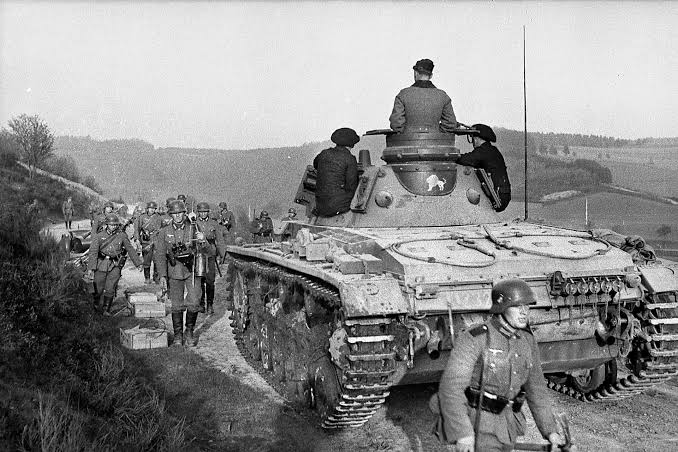 VoicesofWW2's tweet photo. May 10, 1940. Germany launches its attack in the West, and within ten days it pulls off one of the most stunning moves in military history.

While the Allies rush north into Belgium to meet what they think is the main blow, German panzers punch through the Ardennes forest, a place the French considered too rough for tanks. They cross the Meuse at Sedan, break the French line, and race west.

On May 20, German tanks reach the English Channel at Abbeville.

The Allied armies in the north are cut in two. The British Expeditionary Force, the French First Army, and what's left of the Belgians are now trapped in a shrinking pocket with the sea at their backs.

There's only one real way out. Dunkirk.

By May 24, Guderian's panzers are across the Aa Canal, roughly 15 miles from the port. The British have almost nothing between those tanks and the beaches. One hard push and the entire BEF is gone.

Then the order comes down. Stop.

Rundstedt is worried. His armor has been driving nonstop for two weeks, a lot of his tanks are broken down, and the ground around Dunkirk is flat, wet, and full of canals. He wants to save his panzers for the fight against the rest of France. Hitler visits his headquarters and backs him. Göring promises the Luftwaffe can finish off the pocket from the air.

The German army high command thinks it's insane. Guderian is livid. His crews are close enough to see the town, and they just sit there.

For almost three days, they sit.

And the British use every hour of it.

They throw together a defensive perimeter along the canals. Rearguard units dig in. At Calais, a British brigade fights to the last and ties up an entire panzer division. At Lille, the French First Army holds out until May 31 and keeps several German divisions busy that would have otherwise been pushing on Dunkirk.

Meanwhile in London, Operation Dynamo is being thrown together at a desperate pace. Churchill privately hopes they might save 45,000 men.

The halt order is lifted on May 26. By then it's too late to simply roll in. Every mile now has to be fought for.

Over the next nine days, destroyers, ferries, minesweepers, fishing boats, and hundreds of civilian "little ships" run back and forth across the Channel under constant bombing. Most of the men are loaded off a long harbor breakwater called the East Mole. Others wade out from the beaches in chest deep water and wait in line for hours.

The Luftwaffe hits them hard, but bad weather grounds planes on some days and RAF fighters fight over the coast the whole time. Göring's promise doesn't hold.

On the first full day, about 7,700 men get out. By the end, the numbers are staggering.

When it's over on June 4, more than 338,000 Allied soldiers have been evacuated. Around 198,000 British and 140,000 French and other Allied troops.

The British left nearly all their heavy equipment behind. Tanks, trucks, artillery, all of it. But equipment can be rebuilt. Trained soldiers can't be replaced overnight.

Those men became the core of the army that would fight in North Africa, Italy, and eventually land back in Normandy four years later.

Germany had the entire British army trapped on a beach, and it decided to take a break.

Germany won the battle and let the war walk out the front door.