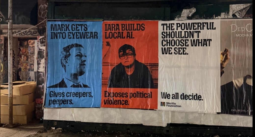 iara_mouse's tweet photo. @mozilla launched a campaign against the tech billionaire class during the UNGA — and my face is in NY. 
The ad places me next to Zuckerberg: he manufactures surveillance eyewear; I build local AI to expose political violence in Brazil, with Instituto Fogo Cruzado. https://t.co/pkZyNrfTSs