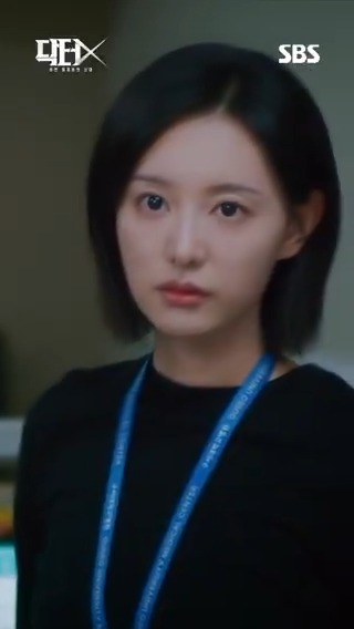 A young woman with a short black bob, wearing a black top and a blue lanyard, stares intensely off-camera with a serious expression, embodying the sharp and defiant tone of the quote. The image is branded with the SBS logo and the Korean title "닥터X" (Doctor X), promoting the upcoming premiere of the drama on October 9 at 9:50 PM.