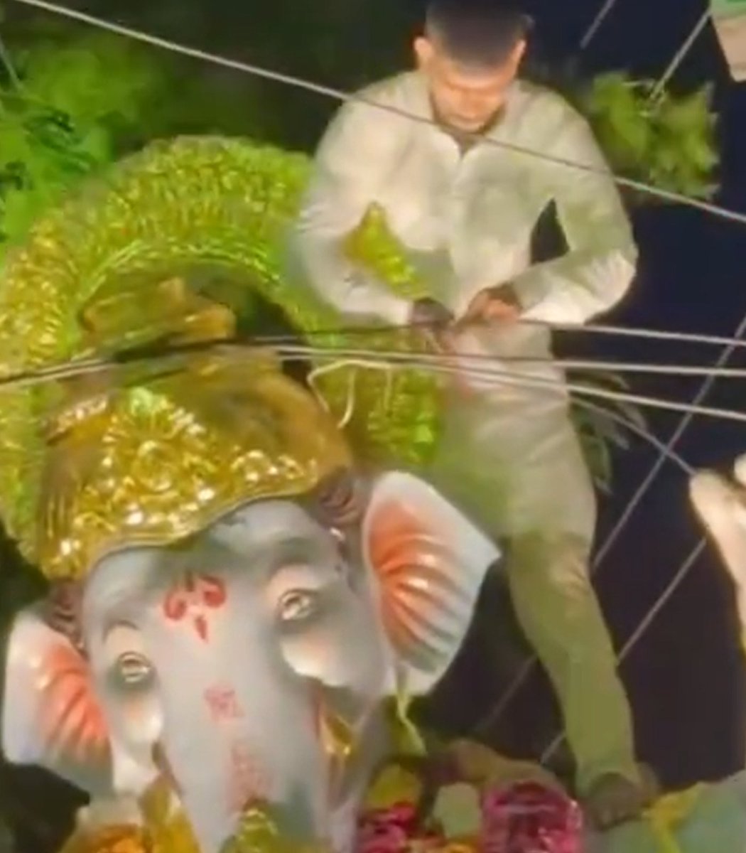 pubity's tweet photo. A man in India climbed atop a giant idol of Ganesh during a procession and cut down telecommunication wires just so the statue could travel through. https://t.co/jR0BTyIWmM