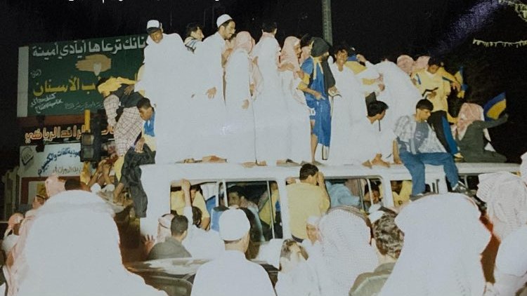 CastroWawa6176's tweet photo. This was a special photo of my father, Harrison Chongo.

I once asked him what was happening in this picture, and he simply said, “That was when we won the league with Al-Taawoun Club in Saudi Arabia.”

The celebrations in Buraydah were incredible. The fans were so excited that some even climbed onto the roof of the moving bus to celebrate with the team.

If you look closely at the photo, you can see Dad peeping through the window, seemingly sharing a moment with some of the fans as the celebrations continued.

A beautiful glimpse into the great memories he made in Buraydah with the team. He always spoke with immense gratitude about the support he received from the club’s management and the fans, acknowledging their important role in helping the team achieve its goals and fulfil its mission.

A special memory of a special chapter in his football journey.