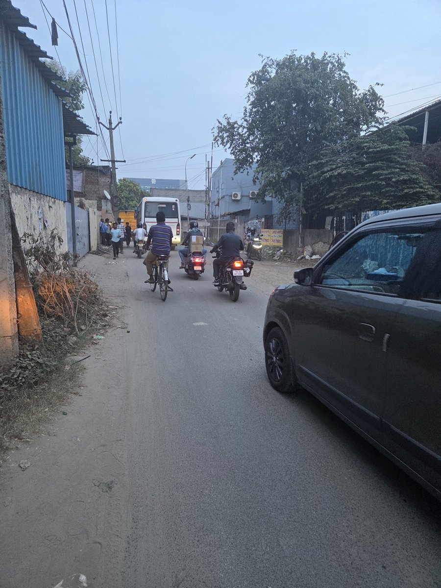 SudsG5's tweet photo. This is not a tier 2 or 3 town, this is not even some distant far flung suburb. 

This is Ambattur industrial estate, it generates employment for 200,000 people. Has an annual turn over of ₹  15,000 crore of which ₹ 3,500 cr is exports. 

It generates income taxes, CGST, SGST, excise and duties. It's support ecosystem (truckers, cleaners, security staff etc) must run into the 10's of thousands. 

It's also an emerging residential real estate hub. The avg per sq in a newer condo is ₹7,500 / 8,000. 

Yet it looks like a war torn dystopia. Has ZERO pavements though 10's of thousands of workers walk from railway stations / bus stops to their factori s and back. 

Large parts of it lack functioning street lights. 

Filthy open sewers, even spotted a few fat pigs in them, cattle, stray dogs, dust everywhere, garbage garbage garbage as far as the eye can see.