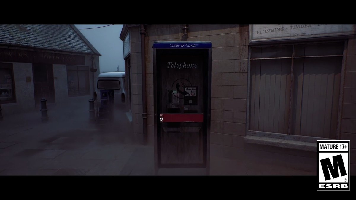 A first-person view from a video game showing a foggy, dimly lit street with a public telephone booth labeled 'Telephone' and 'Coins & Cards,' featuring an ESRB 'Mature 17+' rating logo.