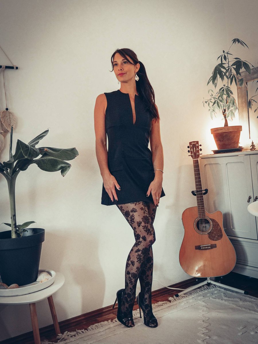 WildyCaro's tweet photo. A black dress, patterned tights, a single lamp for light. Black is never boring, it is just waiting for a detail to carry. https://t.co/a9ToieSgY4