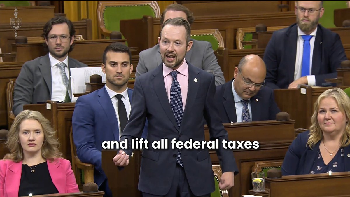 A man in a navy suit and pink shirt speaks passionately in what appears to be the Canadian House of Commons, with the subtitle "and lift all federal taxes" displayed on screen, while other MPs sit in the background. The image aligns with the post's message calling on Prime Minister Carney to eliminate federal carbon taxes to relieve Canadians from high fuel prices.