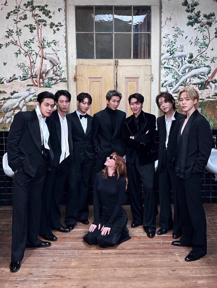 Shade_Crave's tweet photo. 🚨BTS face criticism after a group photo shows a woman kneeling in front of them, with some accusing the group of misogynistic behavior. https://t.co/GO1YqKiYyf