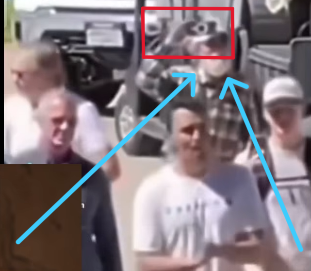 AlexandriaMcCue's tweet photo. The visual anomalies carry right over into the hands when you track the footage closely and in slow motion. Look at the red box with the blue arrows. The hand geometry is a completely distorted, dark gray mass. It doesn't quite mimic human biology. They were clearly operating under an unexpected time crunch because the plan did not go as expected. The rush job shows.

To be perfectly clear, the real Butch Shady was actually on-site the entire time. There's no debating his physical presence. But he doesn't have an unrendered digital void for a face or glitched gray geometric masses for hands.

The mechanism here is clever but sloppy. They used the real Butch walking around after Charlie was taken down as a baseline narrative shield to make us assume the figure at the perimeter was also him. But physical geometry and rushed pixels don’t lie, no matter how much digital paint they throw over the timeline under pressure.

They needed Erika scrubbed from that specific perimeter narrative, but they left the digital receipts all over the footage.