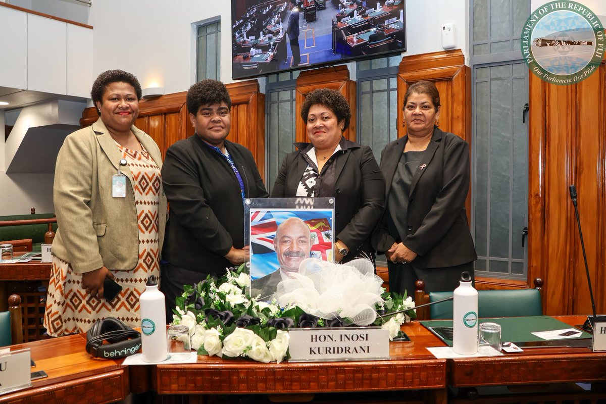 fijiparliament's tweet photo. Ministry of Agriculture, Waterways and Sugar Industry staff paid tribute to their late Assistant Minister Hon. Inosi Kuridrani who passed away over the weekend. They draped his seat in Parliament with black cloth and a wreath. https://t.co/iq0MKOs0YY