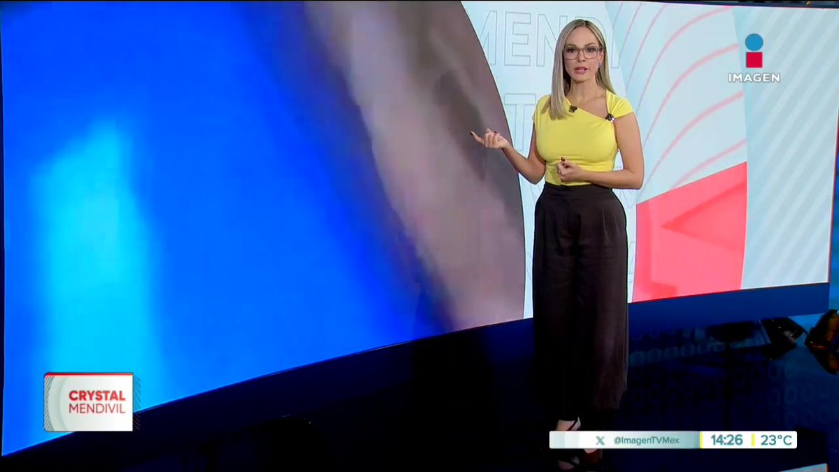 Screenshot from Imagen TV news broadcast featuring anchor Crystal Mendivil in a yellow top and black pants, with timestamp showing 14:26 and temperature 23°C.