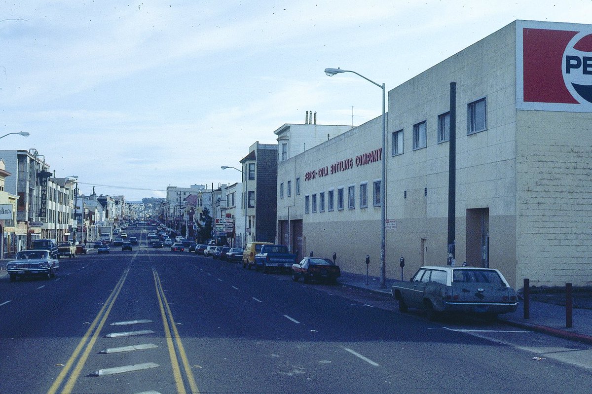 RetroBayArea's tweet photo. There was a Pepsi plant in San Francisco.

It was on Valencia Street, right where the police station is today.

These photos were taken in 1983 as San Francisco was transitioning away from its blue-collar roots. You can see it and feel it in these and other photos from that era. This block of Valencia just looked like a working-class SF street back then, versus the upscale, trendy block it eventually became.

The plant was at 630 Valencia Street.

📸: Max Kirkeberg, 1983