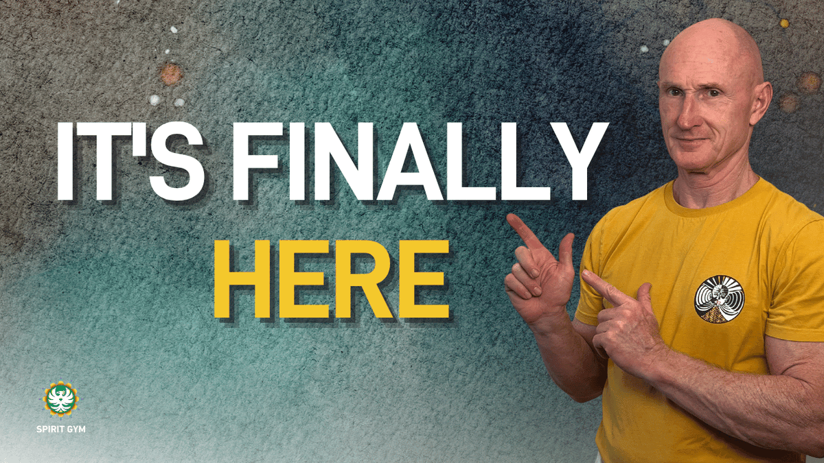 A bald man in a yellow Spirit Gym t-shirt points at bold text reading "IT'S FINALLY HERE" against a teal grunge background, with the Spirit Gym logo displayed in the bottom corner to announce the preorder launch of Spirit Gym Volume 1.
