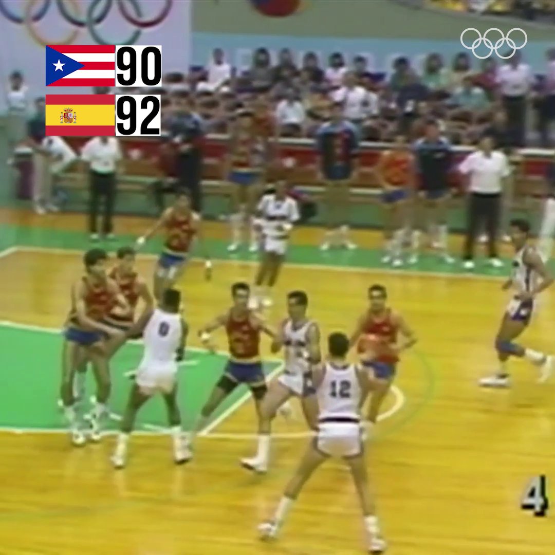 A vintage basketball game image shows the scoreboard displaying Puerto Rico (90) trailing Spain (92) during a men's basketball match, with the Olympic rings visible in the background, capturing the tense final moments before Puerto Rico's historic game-winning three-pointer at the Seoul 1988 Olympics.
