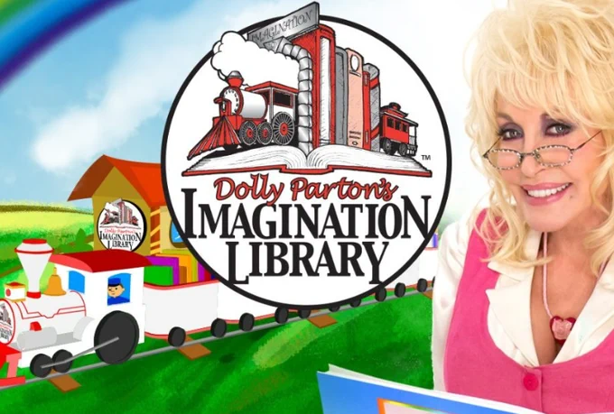 A picture of Dolly Parton with a small train and her logo for Dolly Parton’s Imagination Library.