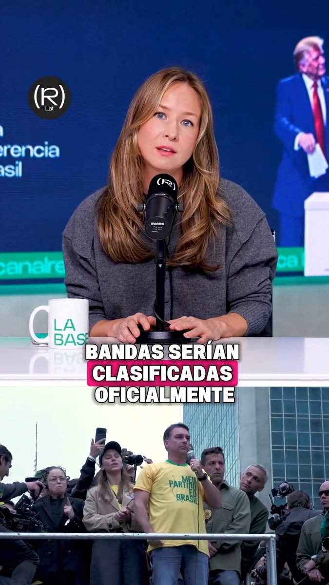 A woman with long blonde hair speaks into a microphone in a news studio with a "La Base" branded mug visible, while the Spanish caption "Bandas serían clasificadas oficialmente" appears over footage of a crowd, including a man wearing a yellow "Meu Partido é o Brasil" shirt. The image relates to the post about US Democratic congress members denouncing interference in Brazil's elections, highlighting concerns over Trump's influence on the Brazilian electoral process.