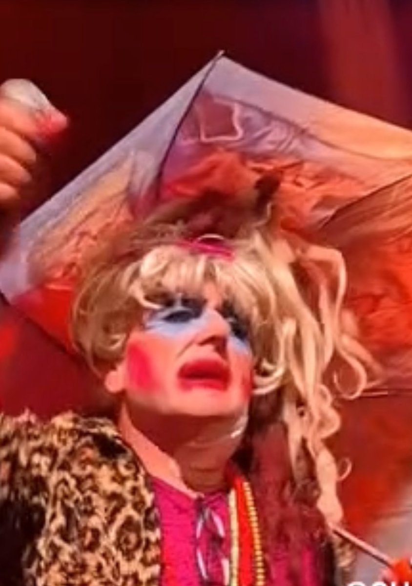 Sorelle_Arduino's tweet photo. At The Anarchist Bookfair a man in drag reads a message from Bash Back urging people to form ‘cells’ and bash back

He then leads a crowd chant of ‘bash back’

These are men advocating violence towards women that say no

This is terrorism https://t.co/tD3dxFLTJE