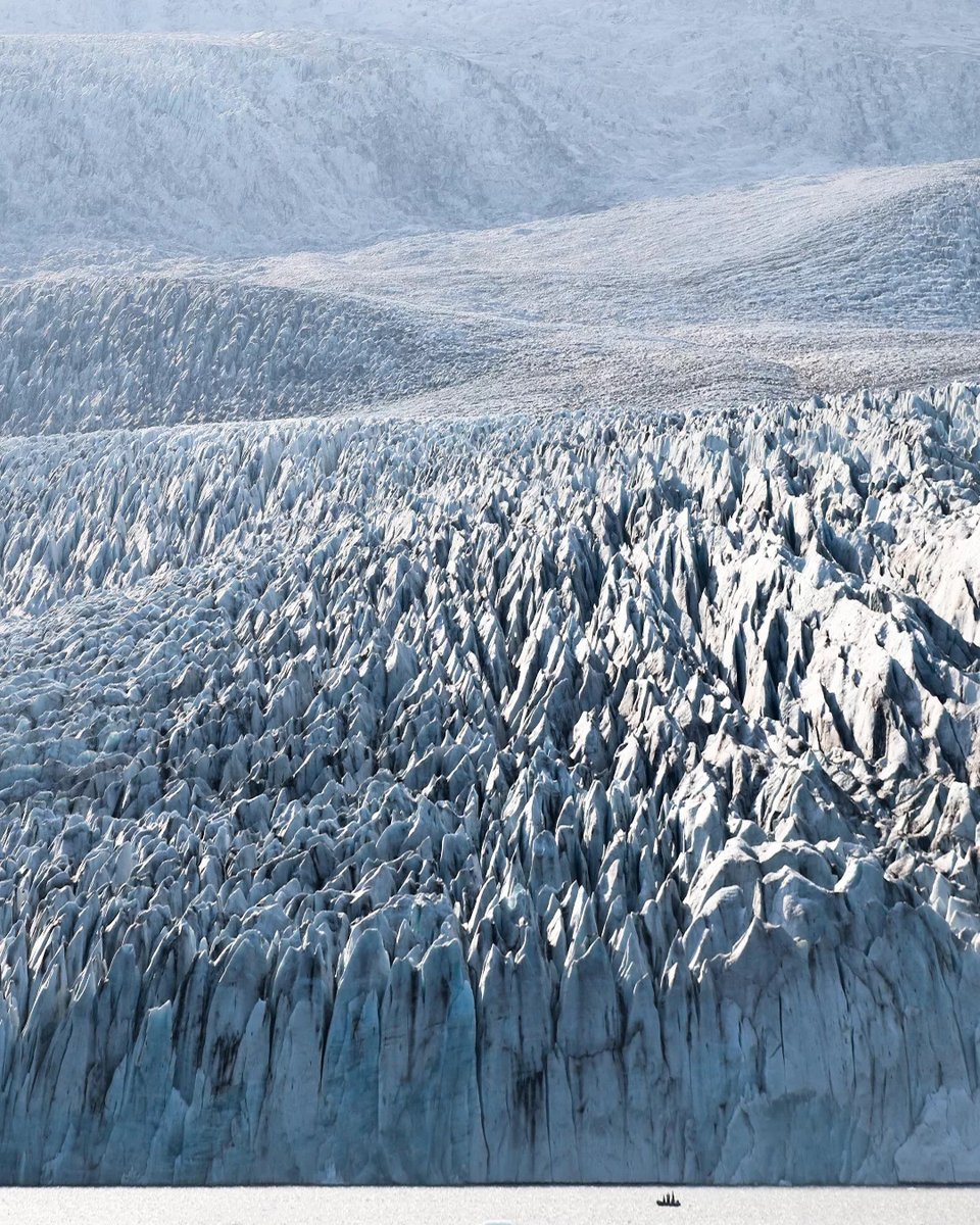 TeixeiraCSilva's tweet photo. Can you see the boat at the bottom of the glacier? Movements of ice, water and tectonic plates have shaped, over millennia, the overwhelming landscape surrounding Vatnajökull. You feel like you're in the Ice Age. Vatnajökull glacier, Fjallsárlón, https://t.co/1t2P33K24d