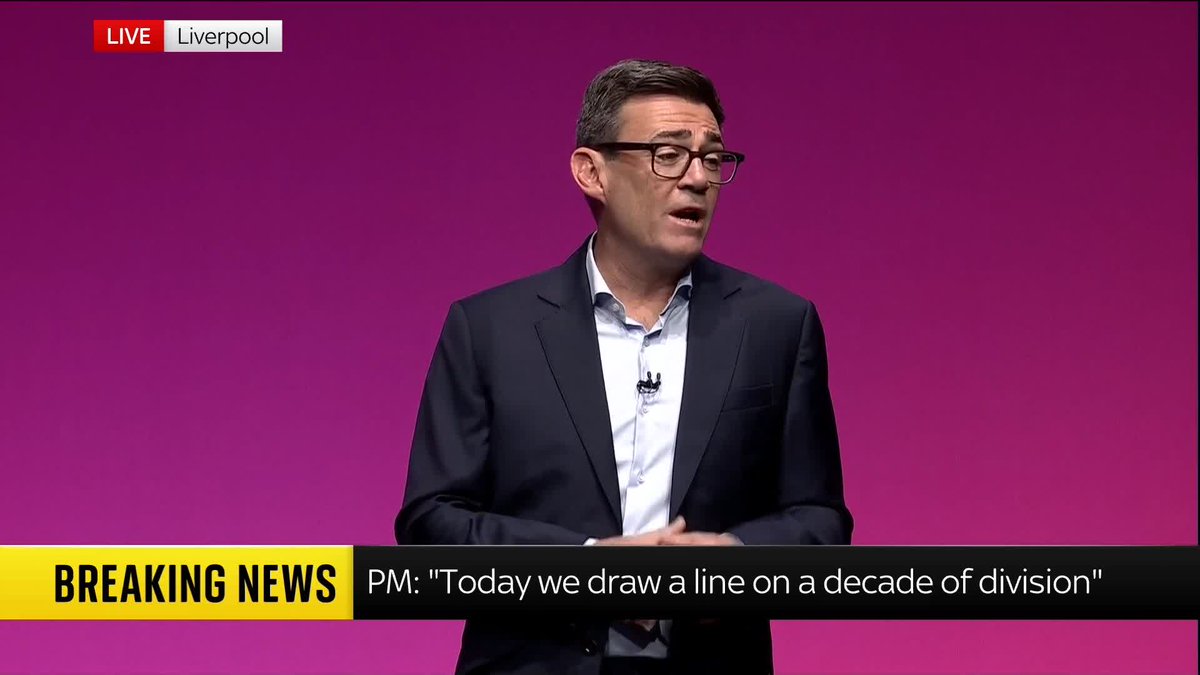 A breaking news broadcast from Liverpool showing a man in glasses and a suit speaking against a magenta background, with the chyron reading "PM: 'Today we draw a line on a decade of division'."