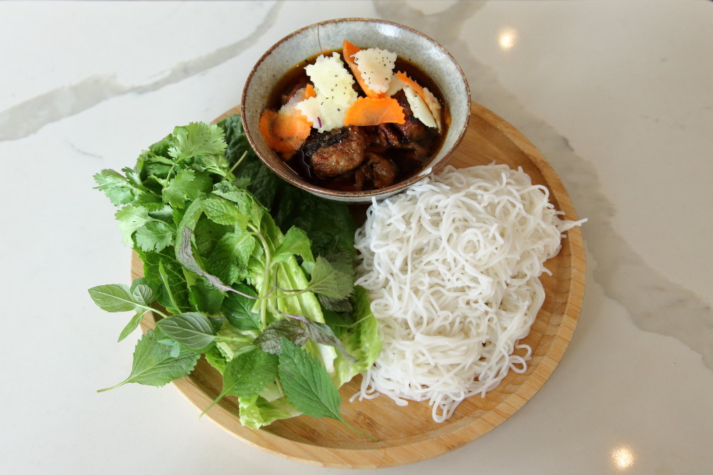 EIT's tweet photo. The most notable herb in this bún chả Hà Nội isn't heaped on the plate. Xương sông, wrapped around minced-pork patties, adds peppery and somewhat astringent notes when the two are chargrilled. It's hard to source in NYC; Ngon Vietnamese Kitchen, on Second Ave., grows its own. https://t.co/FDbvaLK3eN