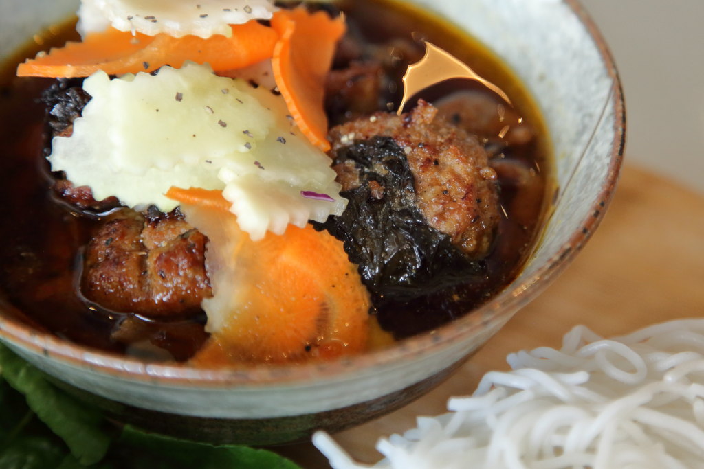 EIT's tweet photo. The most notable herb in this bún chả Hà Nội isn't heaped on the plate. Xương sông, wrapped around minced-pork patties, adds peppery and somewhat astringent notes when the two are chargrilled. It's hard to source in NYC; Ngon Vietnamese Kitchen, on Second Ave., grows its own. https://t.co/FDbvaLK3eN