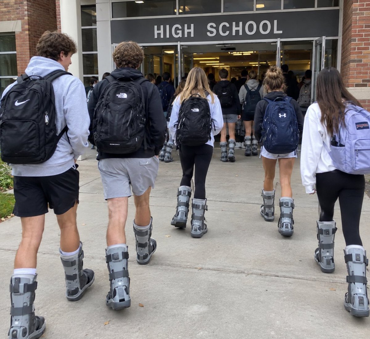 Scaboney's tweet photo. Dropped my son off at HS this morning and was shocked to see all the kids  rocking double boots.  Congrats to @StoolMintzy on starting the new Fall look of 2026!  @nickysmokess https://t.co/kfXTP19dS8