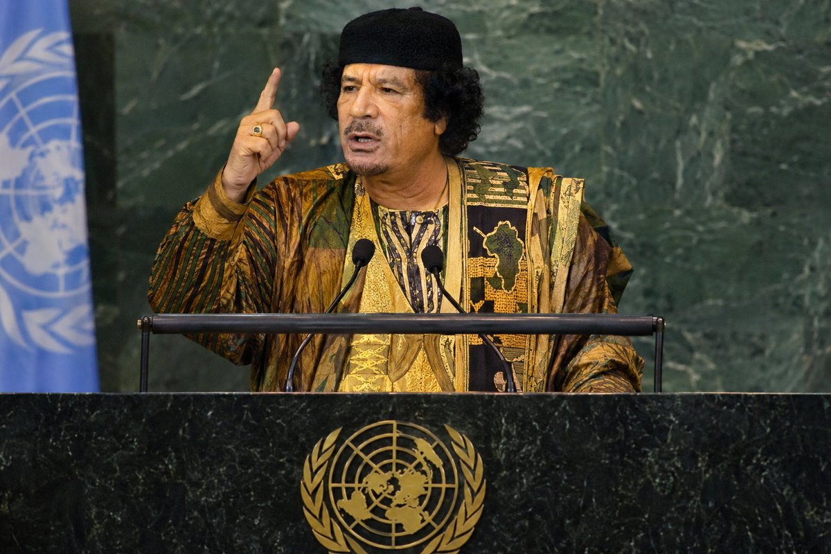 SankaraDispatch's tweet photo. On September 23, 2009, Muammar Gaddafi walked into the UN General Assembly in New York for his first — and ultimately his last — appearance at the UN podium.

He spoke for approximately 1 hour and 36 minutes, delivering one of the most extraordinary speeches in the history of the General Assembly.

He was speaking not only for Libya, but also on behalf of the African Union and the African people.

Gaddafi's central target was the UN Security Council and the veto power of its five permanent members.

He argued that the UN Charter's principle of sovereign equality was fundamentally contradicted by a system in which five countries could veto decisions affecting the rest of the world.

He questioned why the countries that created the UN should retain privileges that allow them to determine the fate of nations that were not even represented when the organization was founded.

He pointed to the Charter's prohibition on aggression and interference in the affairs of sovereign states and contrasted those principles with what he described as decades of wars, interventions and sanctions by the US and other veto members.

He attacked the Security Council as a system of “security feudalism,” arguing that it did not provide genuine security to the world but allowed major powers to impose sanctions and military force according to their own interests.

He rejected the idea that Security Council resolutions should automatically be obeyed when, in his view, the Council itself violated the principles of the Charter.

Then he turned to Africa.

Gaddafi argued that Africa deserved a permanent seat on the Security Council because of the continent's historical suffering and exclusion from global decision-making.

He went further, calling for compensation for Africa over the wealth and resources extracted during colonial rule — estimating the historical debt at approximately $77.7 trillion — and argued that colonization itself should be criminalized.

He also criticized the location of the UN headquarters in New York, arguing that the annual General Assembly should rotate between different regions of the world rather than remaining permanently in the United States.

Then he trained his guns on the international response to Palestine, criticizing Israel over settlements, Palestinian prisoners, refugees and the absence of a Palestinian state.

He advocated a system in which Muslims, Christians and Jews could live with equal rights in a single state.

At one point, Gaddafi held up a copy of the UN Charter and dramatically tore it apart.

The symbolism was unmistakable.

He was arguing that the international system claimed to be built on sovereign equality while maintaining a hierarchy in which a handful of powerful states possessed extraordinary privileges.

On that day, on that podium, Gaddafi made countless enemies.

The UN itself recorded the speech as lasting about 1 hour and 36 minutes; UN footage describes it as Gaddafi's first and last appearance at the General Assembly podium.

Then, just two years later, in 2011, Libya conveniently descended into chaos.

The West funded and backed an uprising against Gaddafi, while the very Security Council he had condemned authorized military action against Libya.

NATO then launched a massive bombing campaign.

NATO warplanes struck Libyan targets from the air for months.

Eventually, NATO aircraft struck Gaddafi's convoy as he was fleeing Sirte.

Gaddafi was captured alive by Western-backed rebel fighters.

What followed was horrific.

He was beaten, tortured and ultimately killed.

His son Mu'tassim Gaddafi was also captured and killed.

The UN justified the intervention as an effort to "protect civilians".

But Libya was left devastated — to date. 

Libyans have continued to live with the consequences of that "intervention" for more than a decade.

Gaddafi was killed in October 2011.

But the questions he raised at the UN in September 2009 did not die with him.