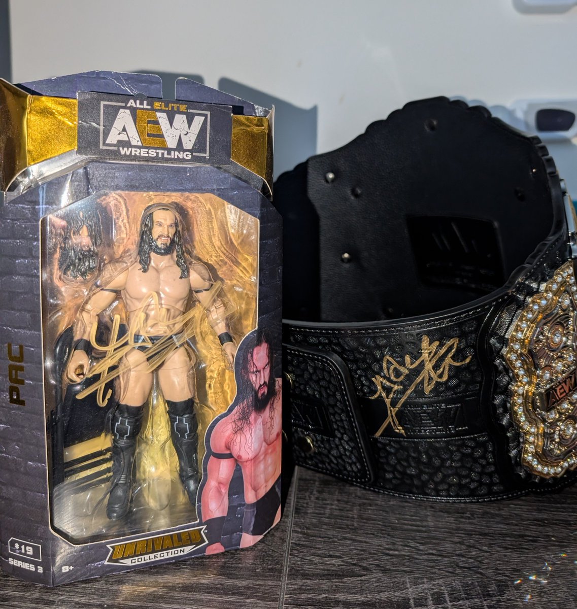 AllEliteLuke's tweet photo. Only a month ago PAC signed both my AEW World Title and figure. I will cherish these items forever ❤️. https://t.co/Qq1nhSZmac