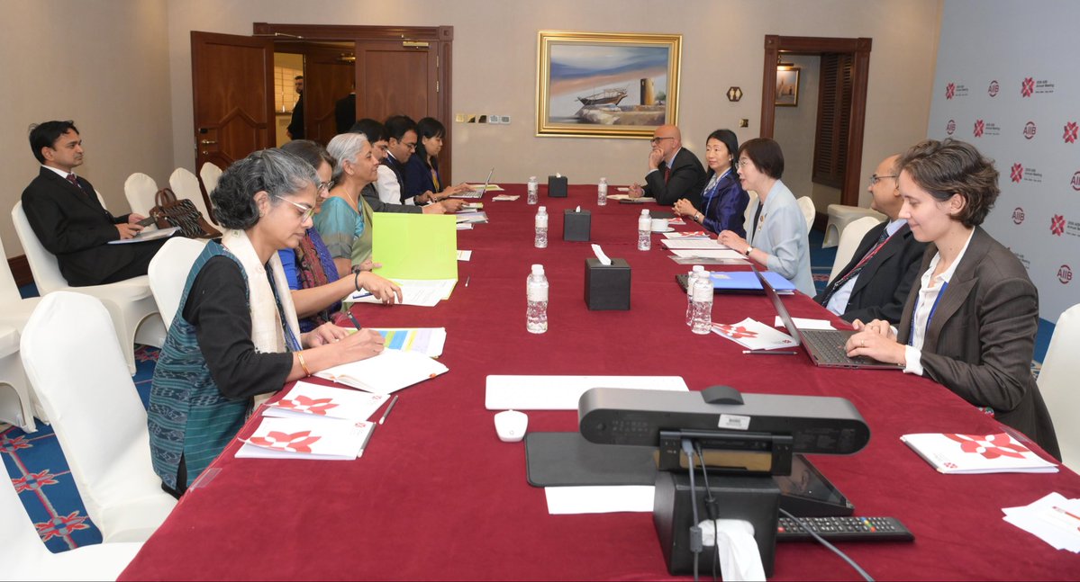 FinMinIndia's tweet photo. Union Minister for Finance & Corporate Affairs Smt. @nsitharaman met Ms. Zou Jiayi, President, Asian Infrastructure Investment Bank @AIIB_Official, on the sidelines of the AIIB 2026 Annual Meeting in Doha, Qatar, today.

President @AIIB_Official congratulated the Union Finance Minister on the successful BRICS Leaders' Summit in New Delhi. 

The Union Finance Minister congratulated AIIB on its strong performance in the first half of the year. She conveyed India's support for the Bank's 2027 budget plans and focus areas for scaling up operations. 

Both the leaders discussed the robust pipeline of AIIB's projects in India and expanding the global presence of AIIB, including in India.

Recalling her last visit to project sites in Delhi and Meerut, President AIIB said that the bank will continue financing projects for people, urban development and environmental protection.

The Union Finance Minister said AIIB could further expand beyond physical infrastructure financing to include newer infrastructure that focuses on AI, MSMEs, and skilling. FM noted that MSMEs are the backbone of India's economy, and assistance for AI adaptability and manpower training can help MSMEs.

FM Smt. @nsitharaman reiterated that the Bank's regional centrality should continue to remain a defining institutional characteristic and an important anchor of its mandate.
