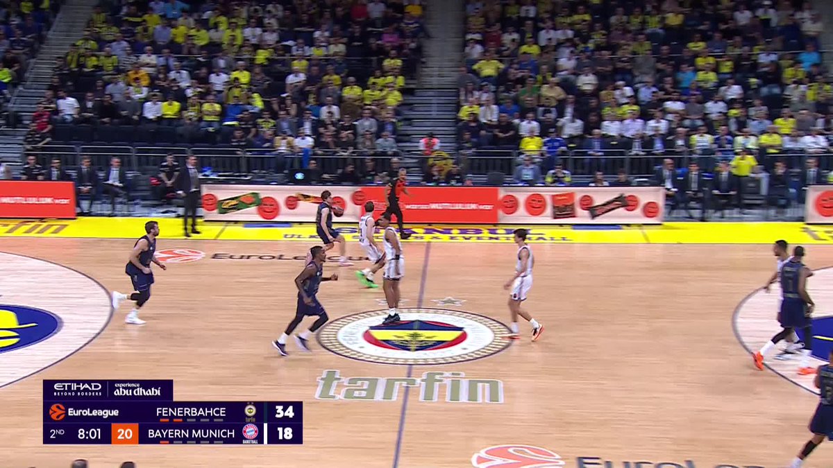 A basketball game is in progress between Fenerbahçe and Bayern Munich, with Fenerbahçe leading 34-18 at 8:01 in the 2nd quarter, as a player in white appears to be making a fast break toward the basket. The scene aligns with the caption celebrating an exciting, airborne moment from Fenerbahçe Basketball's game, with the team prominently featured on the scoreboard and court logos.