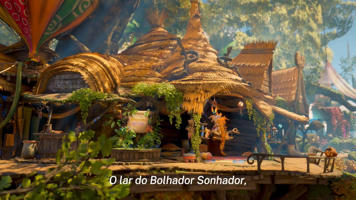 A whimsical thatched-roof shop nestled in a lush tree village setting, with Portuguese subtitles reading "O lar do Bolhador Sonhador," translates to "The Dreamer Bubbler's Home." The image depicts the home of the Dreamer Bubbler character from the Rayman video game series, complementing the post's invitation to explore the Tree of Tranquility and its hidden adventures.